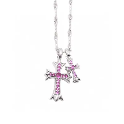A fine silver-tone chain necklace with a cross pendant set with pink stones, photographed on a white background